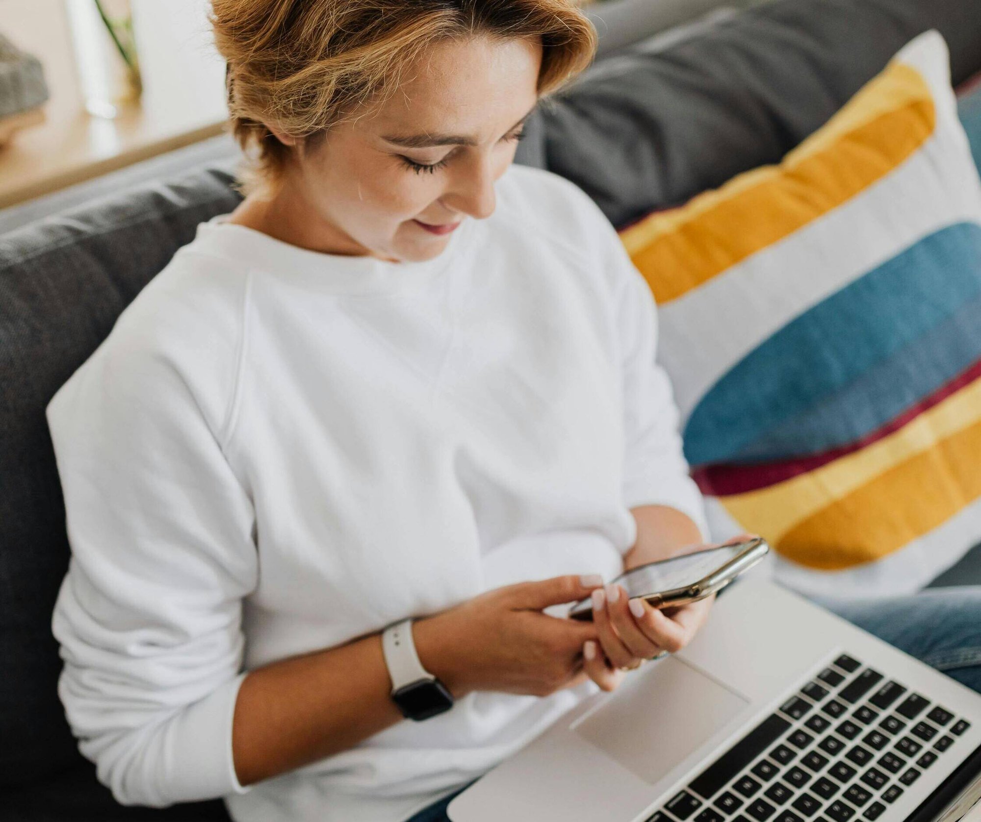 woman-using-phone-and-laptop-ecommerce-shopping-online